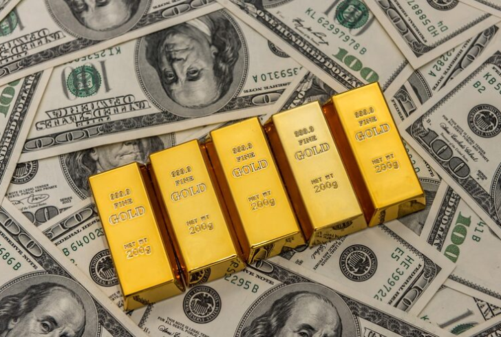 Gold bars shining beside dollar notes