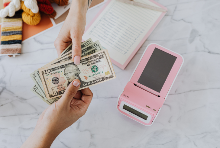 Customer paying cash at small shop
